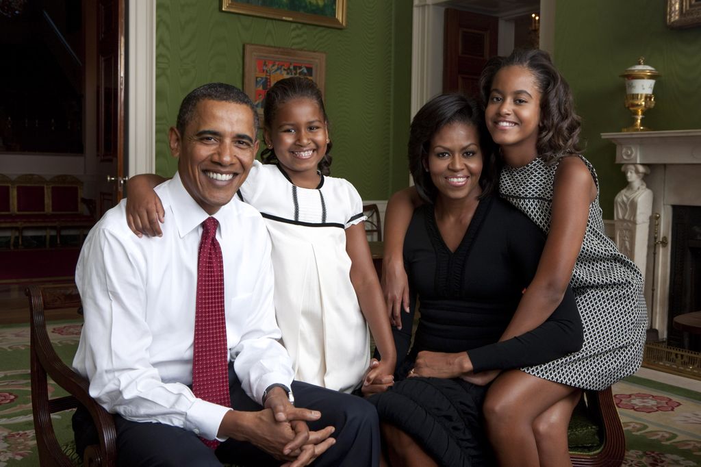 U.S. President Barack Obama, daughter Malia Obama, first lady Michelle Obama and daughter Sasha Obama sit for portrait in the Green Room of the White House