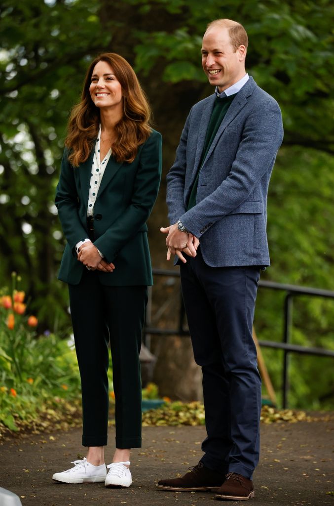 William and Kate smiling in a park
