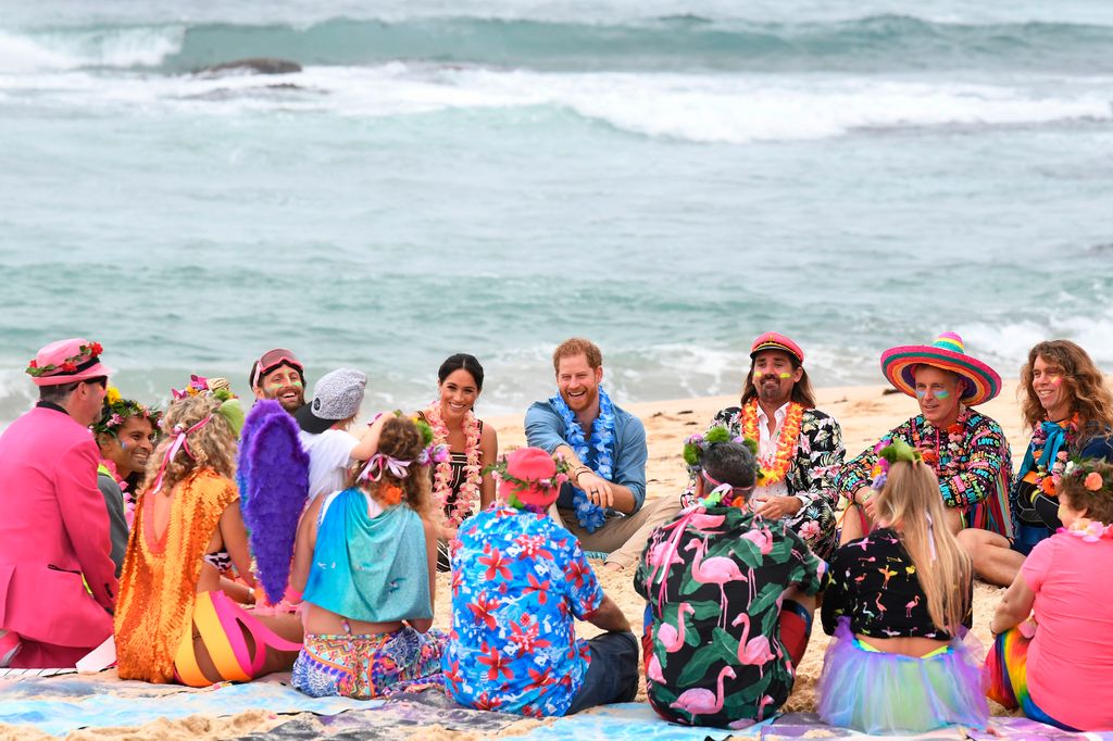 Prince Harry and Meghan take part in a "Fluro Friday" session run by OneWave, a local surfing community group who raise awareness for mental health and wellbeing, at Bondi Beach in Sydney on October 19, 2018