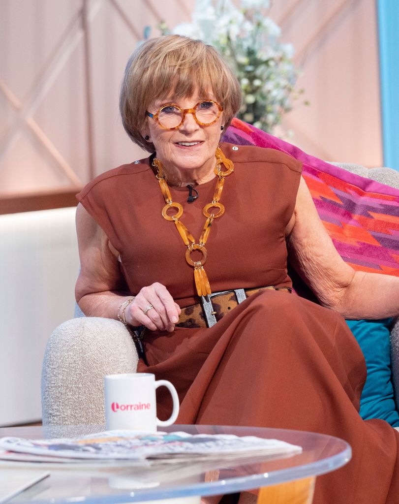 anne robinson sat on sofa 