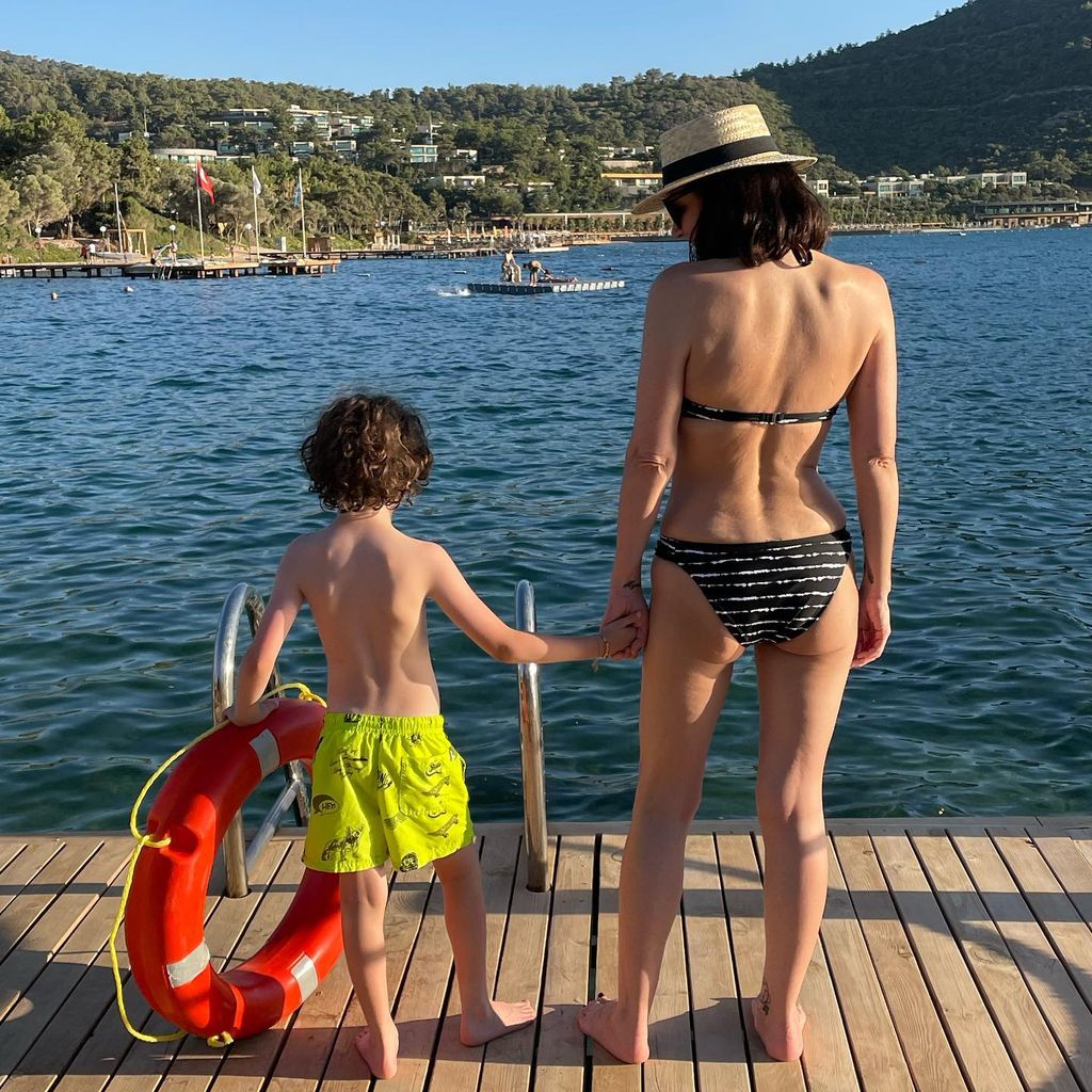 Martine holding her son's hand on holiday 