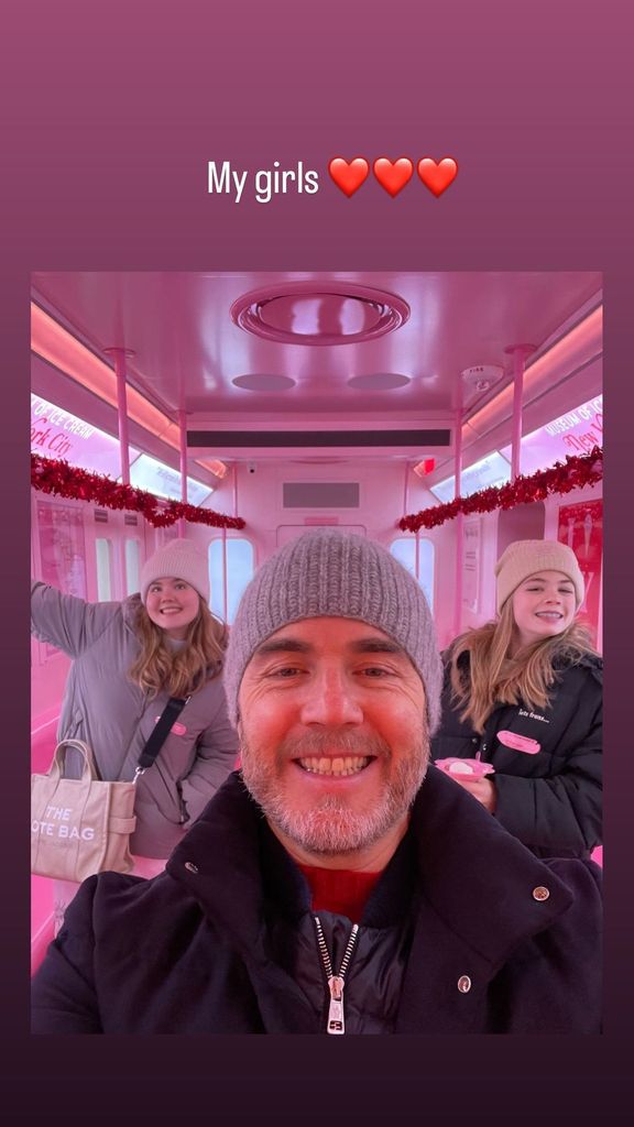 Gary posing for a selfie with his two daughters