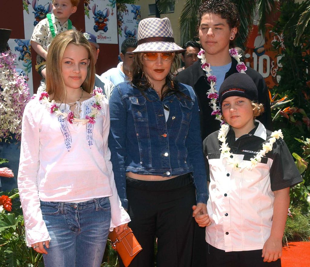 Lisa Marie Presley and her children Benjamin Keough (R),  Riley Keough (L), and her half-brother Navarone Garibaldi (back) attend the premiere of "Lilo and Stitch" at the El Capitan theatre in Hollywood on June 16, 2002