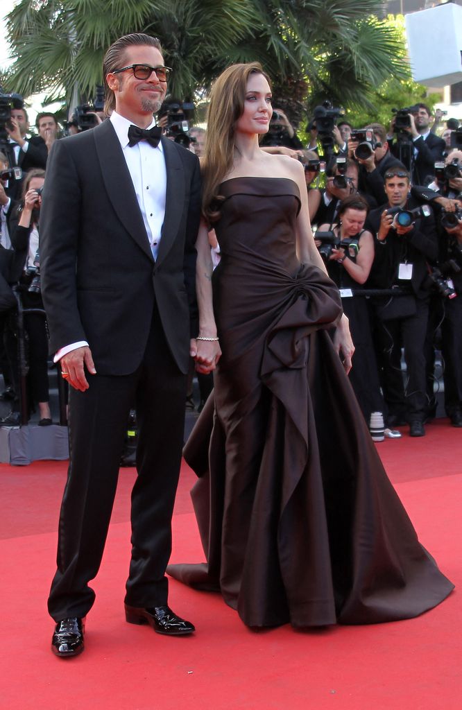 Brad Pitt and Angelina Jolie pose on the red carpet before the screening of "The Tree of Life" 