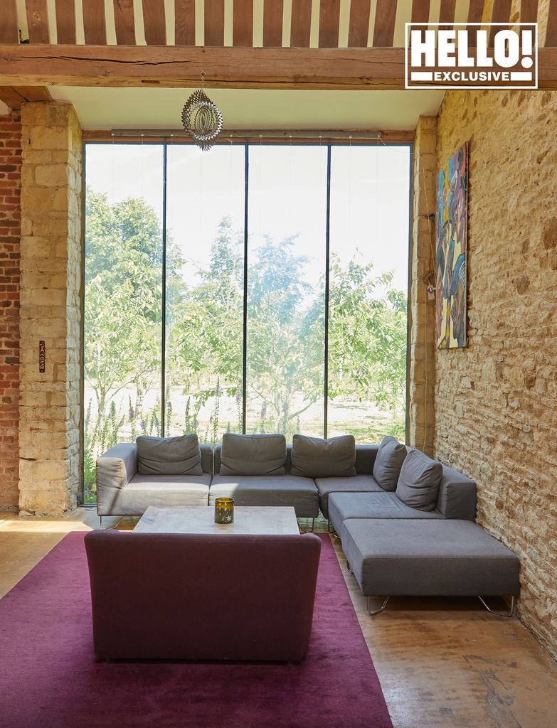 Blur star Alex James's living room with stone walls at Kingham farmhouse