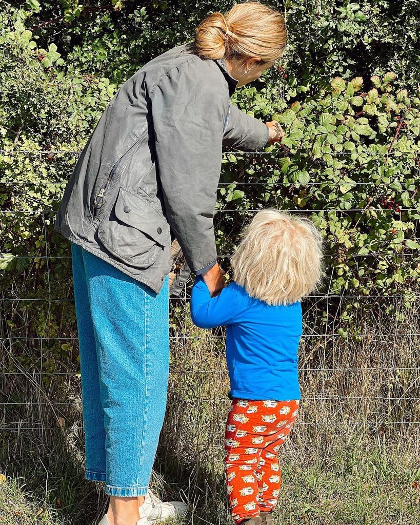 Carrie Johnson picking blackberries with Wilfred