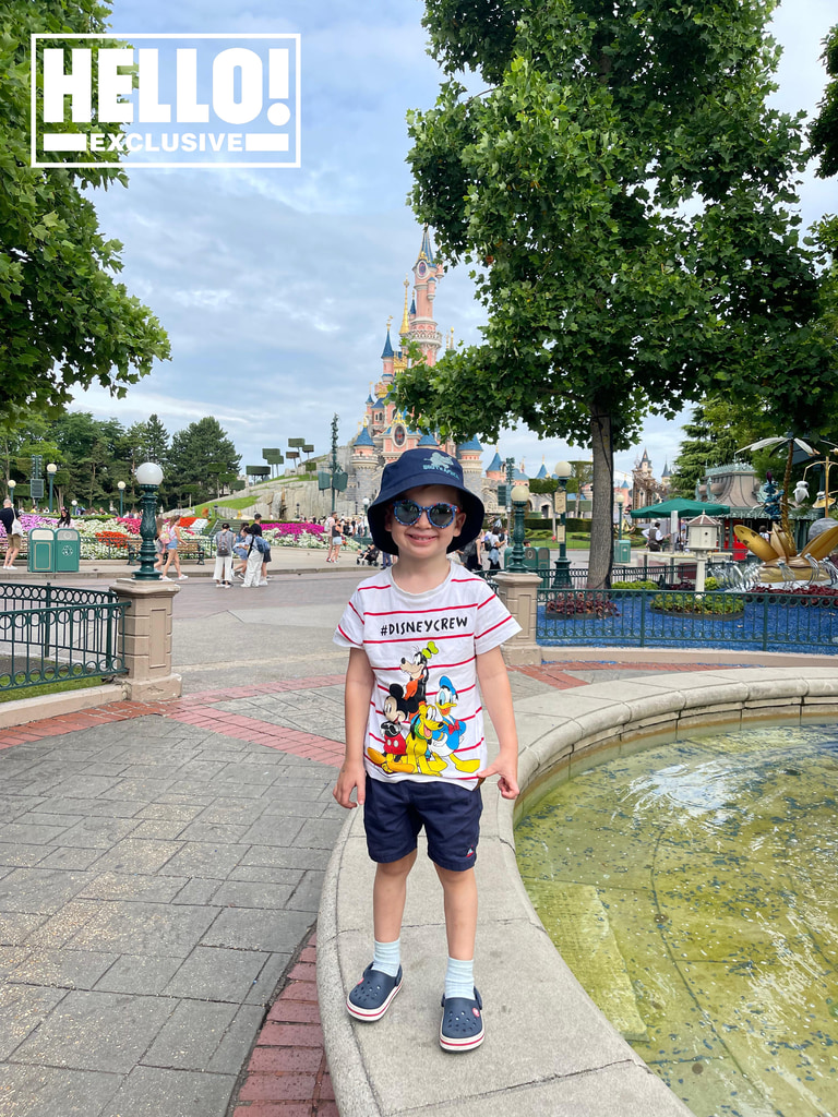 Rebecca's son Albie standing in front of Euro Disney castle in Paris