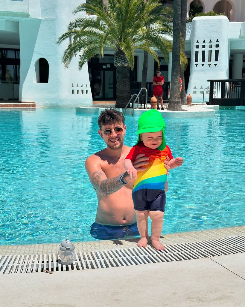 father looking after son in swimming pool 