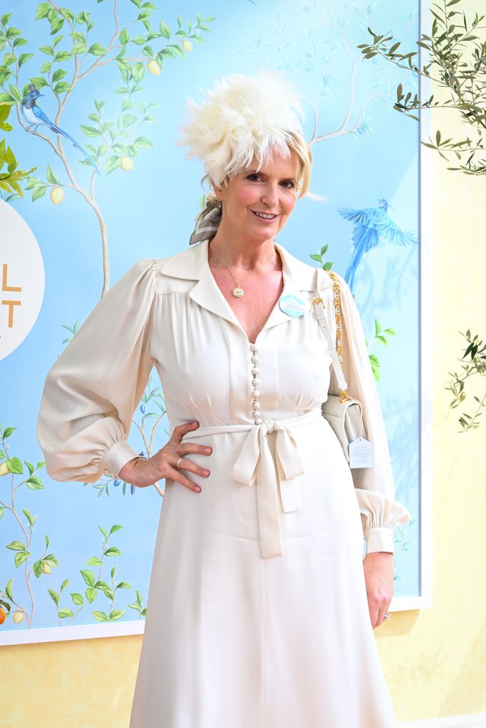 Penny Lancaster  in cream dress with hand on hip