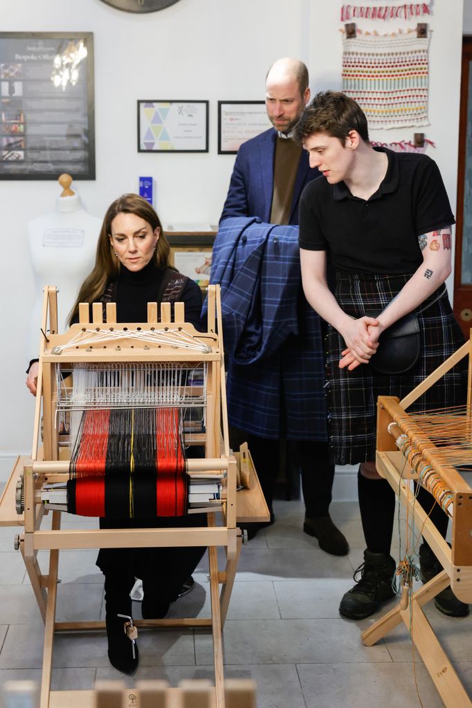 William held Kate's coat as she tried her hand at tartan weaving