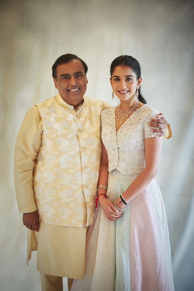 Radhika posing with Anant's father Mukesh Ambani