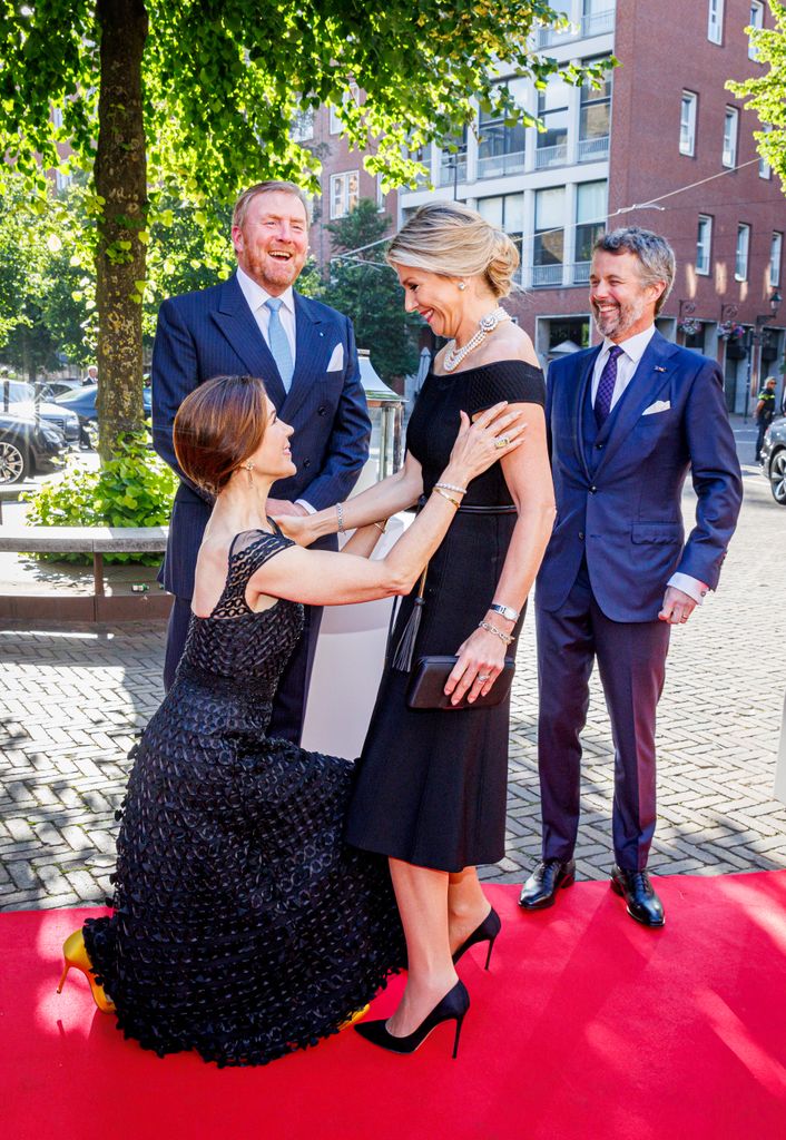 Princess Mary curtsies to Queen Maxima of The Netherlands