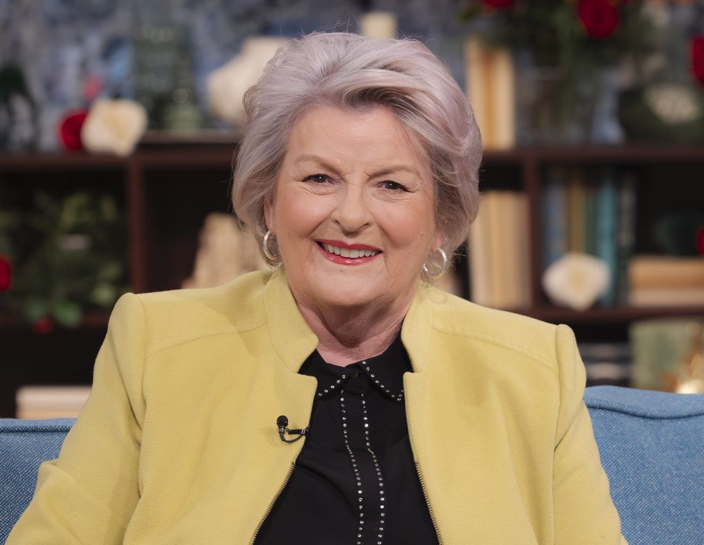 close-up of woman sitting on blue sofa in tv studio