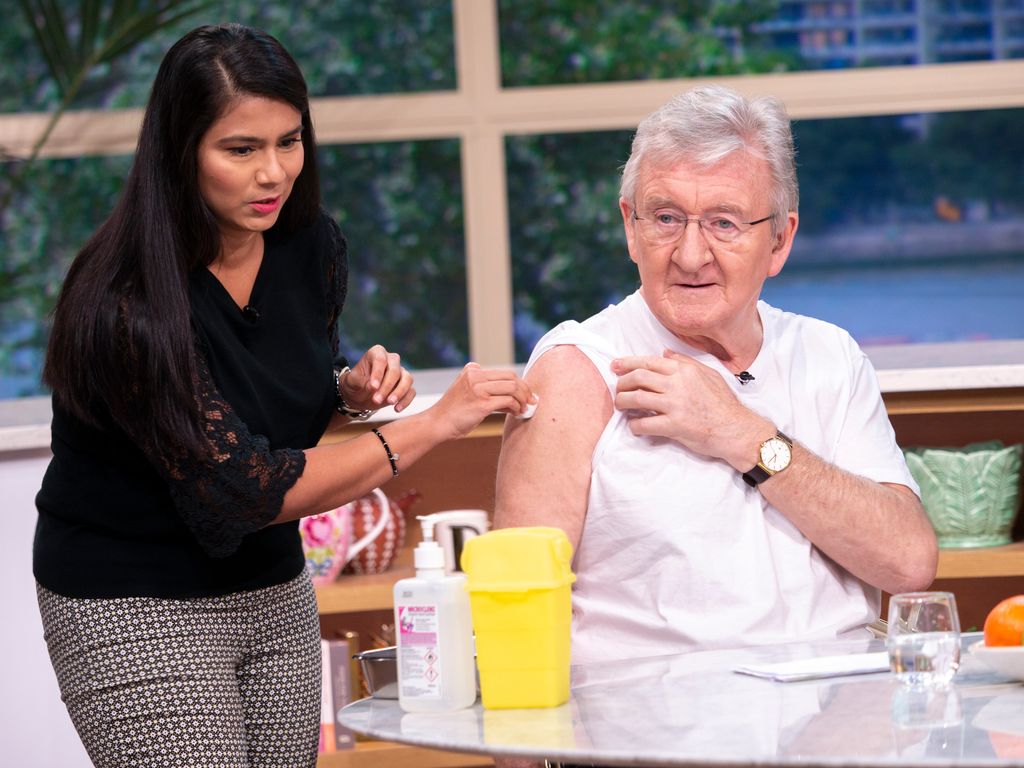 Dr. Chris Steele receiving an injection on TV