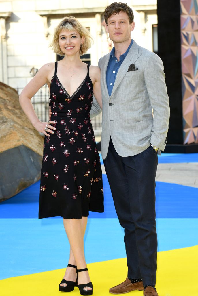 Imogen Poots in a black dress with James Norton