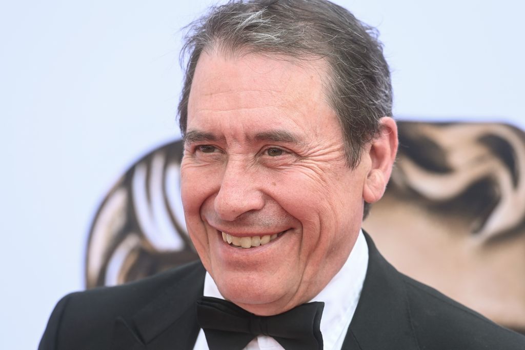 Jools Holland smiling in a bow tie at the baftas