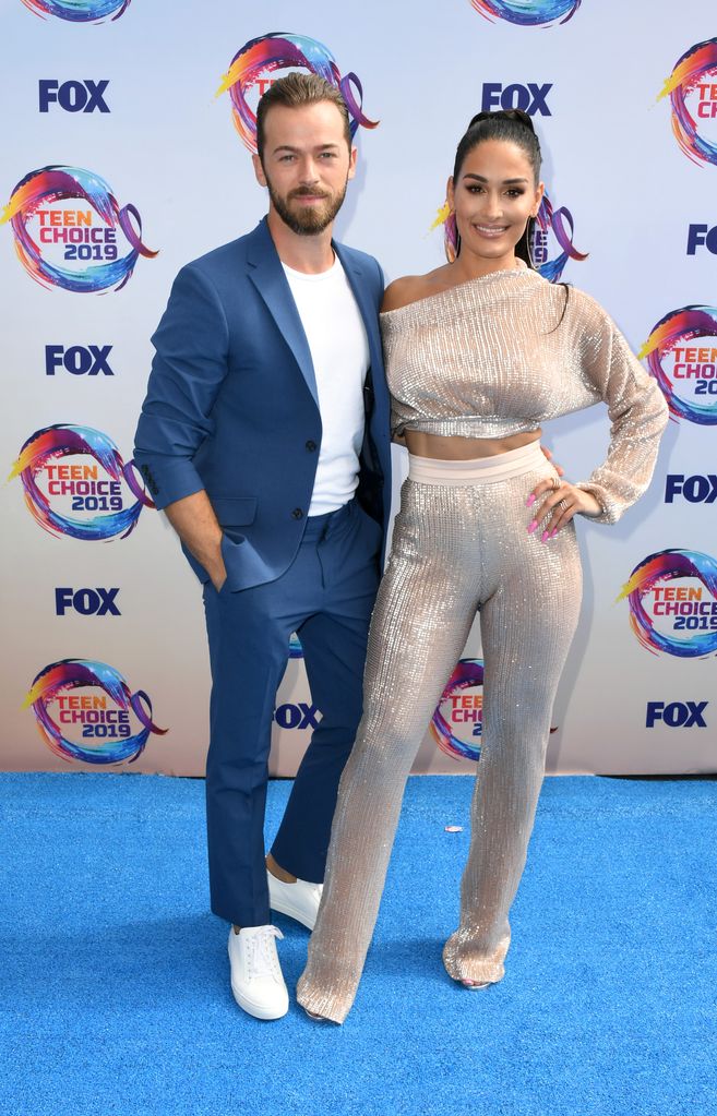 Artem Chigvintsev (L) and Nikki Bella attend FOX's 2019 Teen Choice Awards