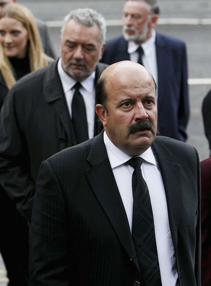 Willie Thorne wearing a black suit
