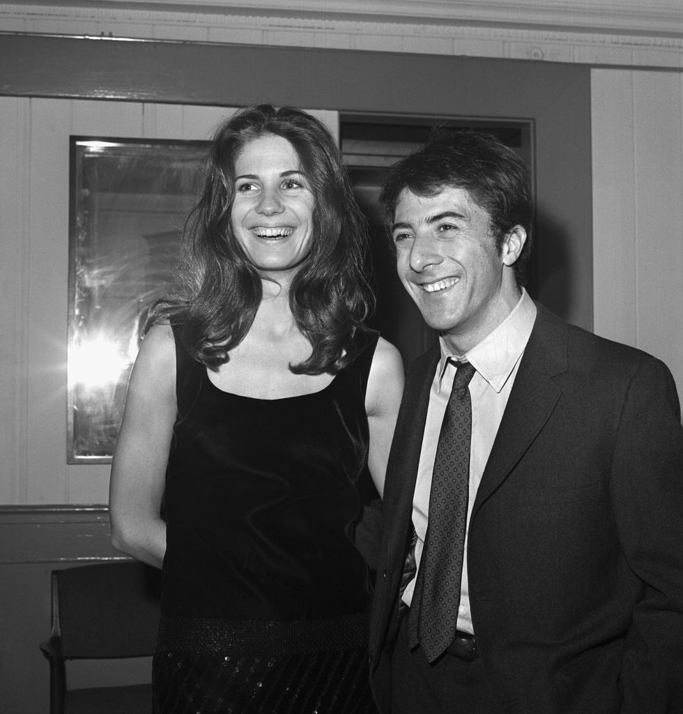 Actor Dustin Hoffman and his girl friend, Ann Byrne, smiles for photographers during party at Sardi's here late Dec. 5th following the premiere of his first Broadway starring role in "Jimmy Shine." Hoffman is the off-Broadway actor who became an over night star as a result of his playing in "The Graduate" motion picture.