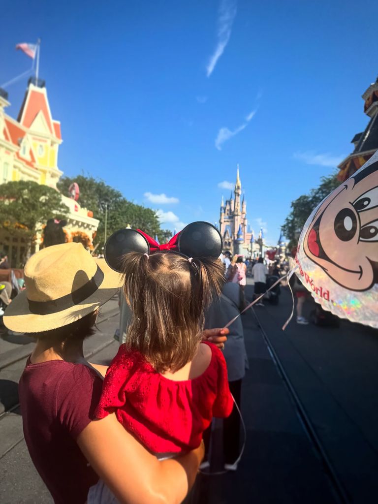 Janette and Lyra from behind with disney castle