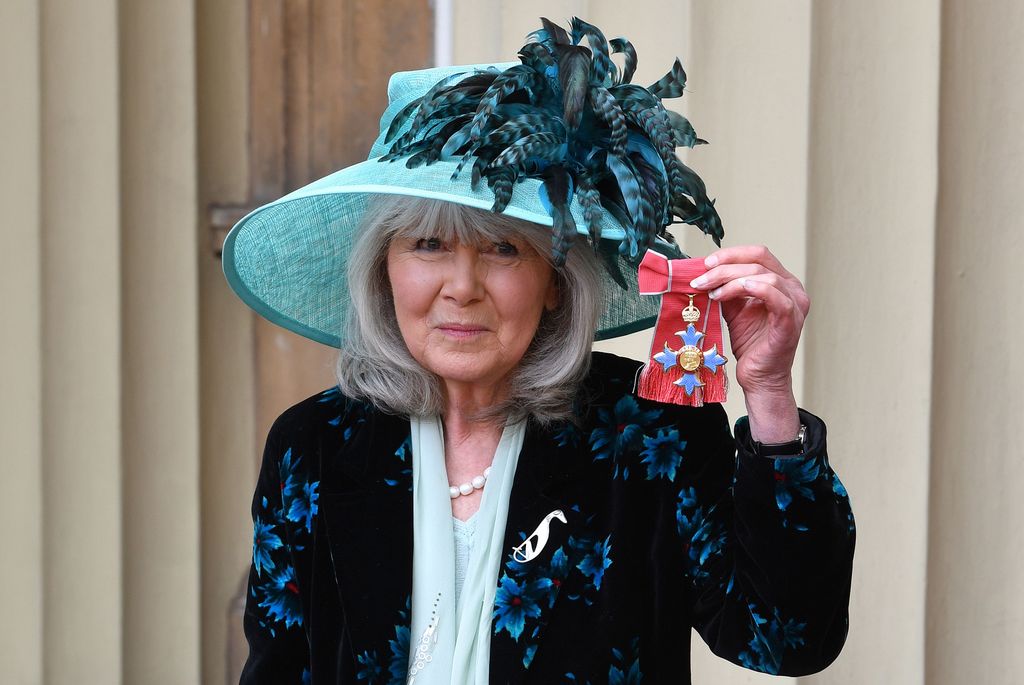 Author Jilly Cooper poses with her medal after she was appointed a Commander of the Order of the British Empire (CBE) at an investiture ceremony at Buckingham Palace in London