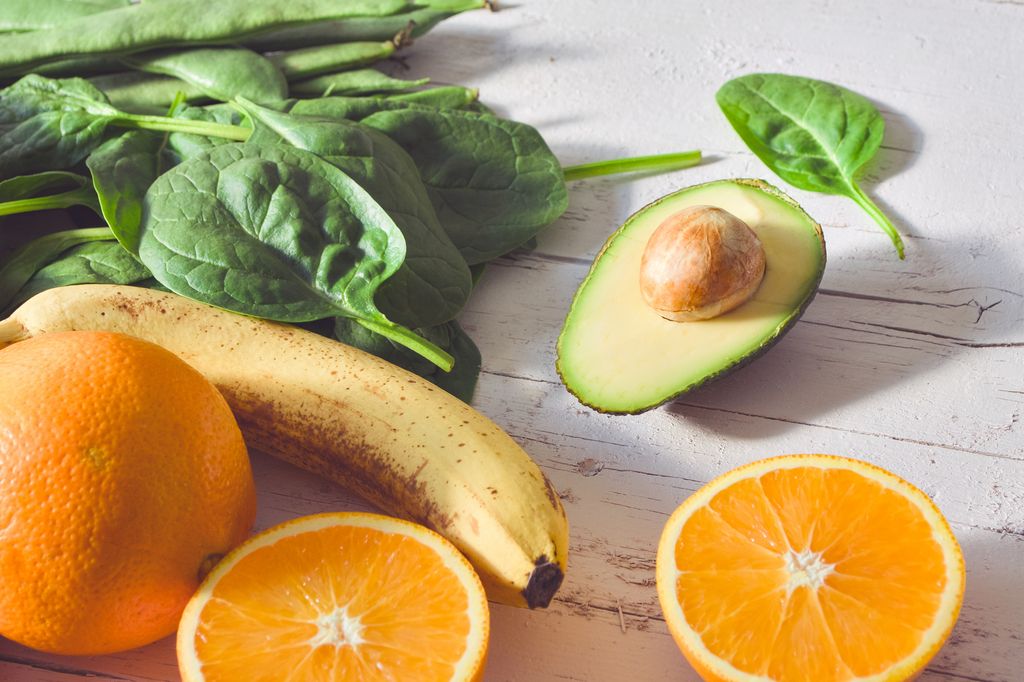 Multi colored vegetables and fruits on wooden table - vegetables and fruits in rainbow colors on rustic white wooden table