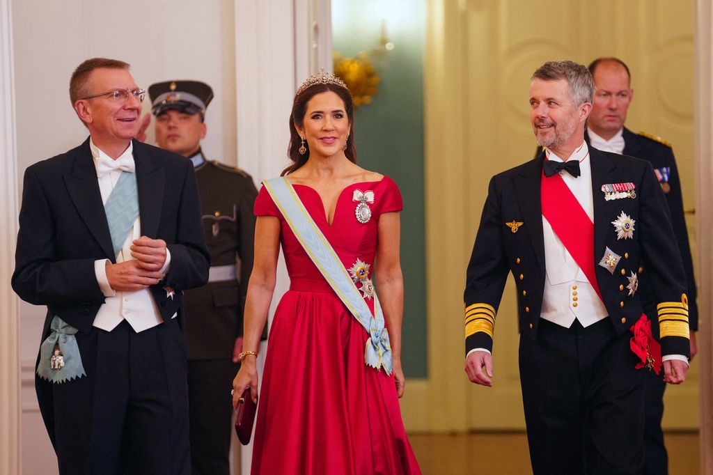 Denmark's King Frederik and Queen Mary arrive for the State dinner hosted by Latvia's President Edgars Rinkevics (L) at Riga Castle    