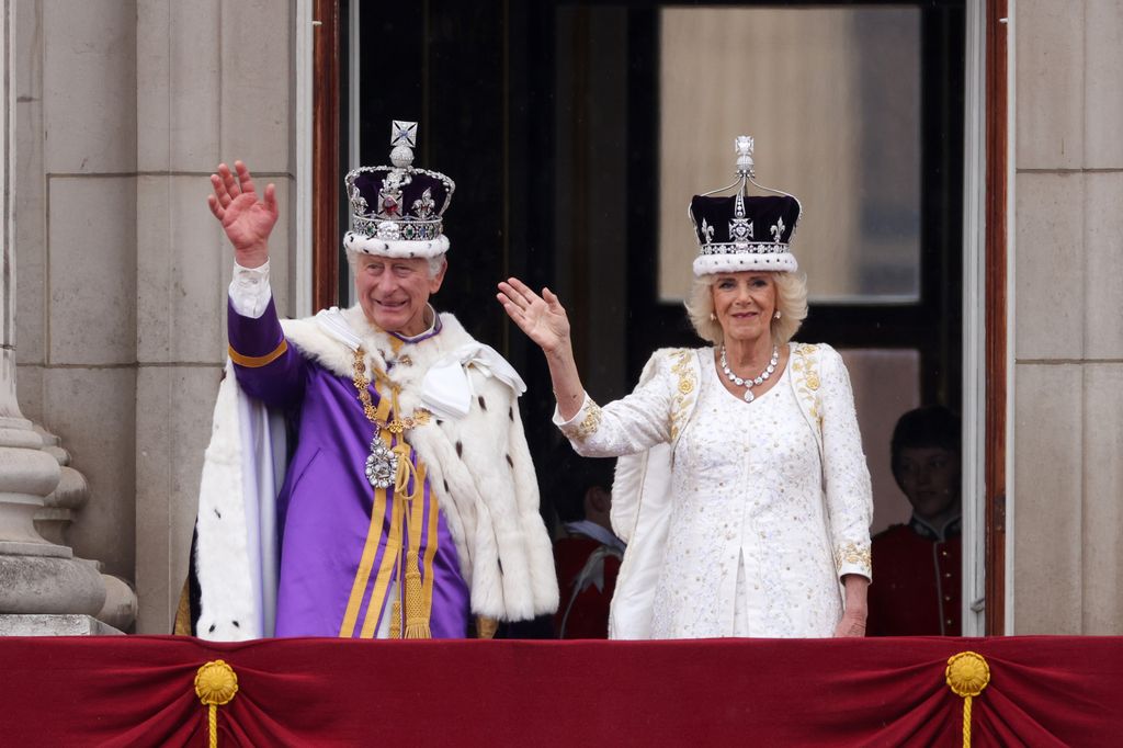 The newly-crowned King and Queen wave to the crowds
