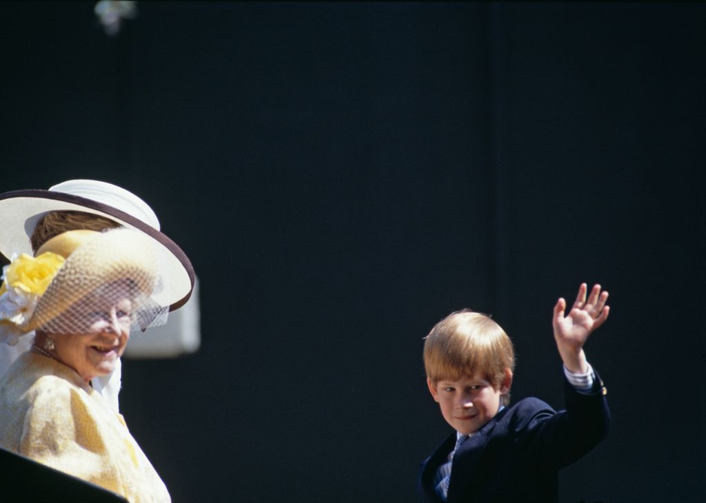 Prince Harry waves as he travels in an open carriage with his mother and Queen Elizabeth, the Queen Mother to watch the Trooping the colour Ceremony in June, 1992