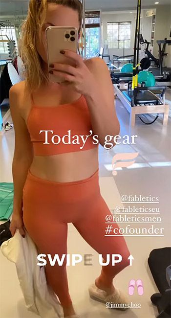 Kate Hudson bares her abs in a pink sports bra and leggings for