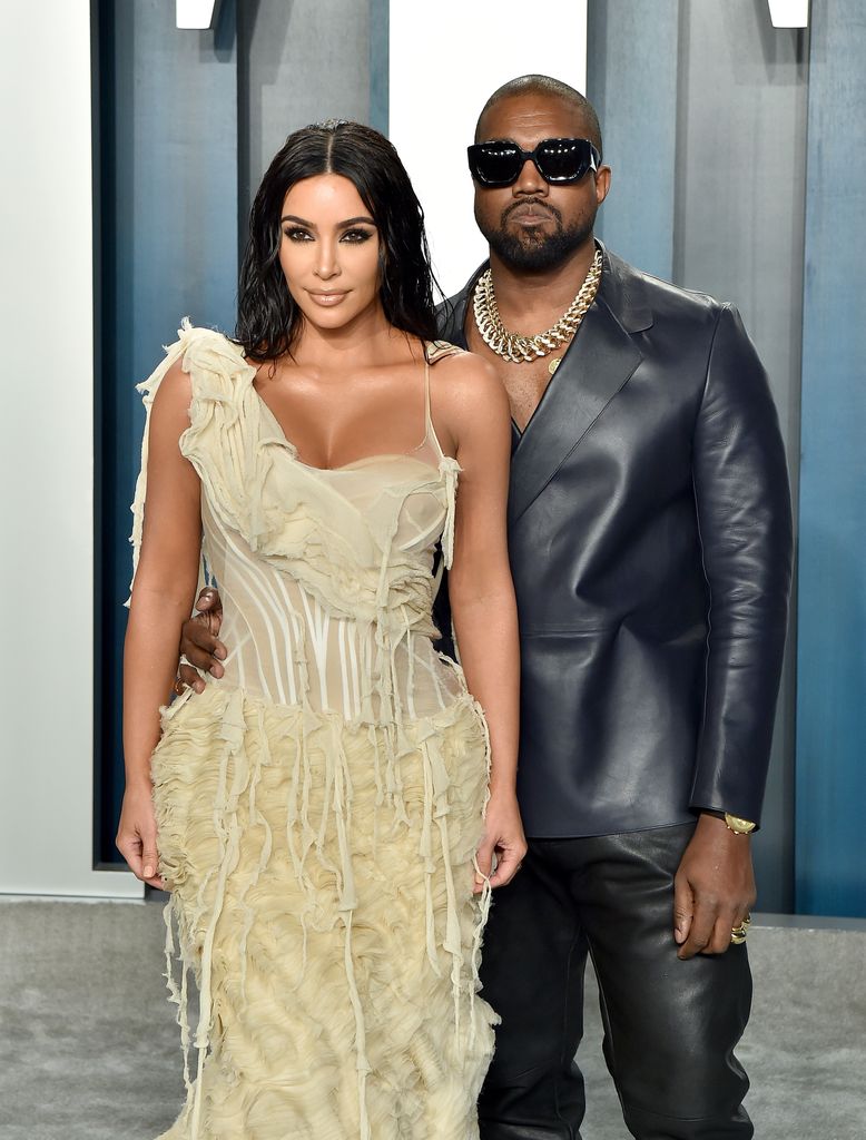 Kim Kardashian and Kanye West posing for a red carpet photo together