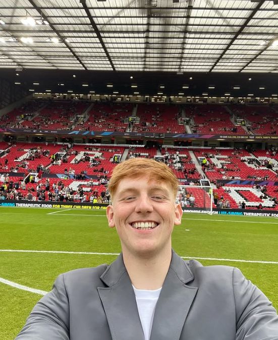 Angry Ginge smiling inside a football stadium