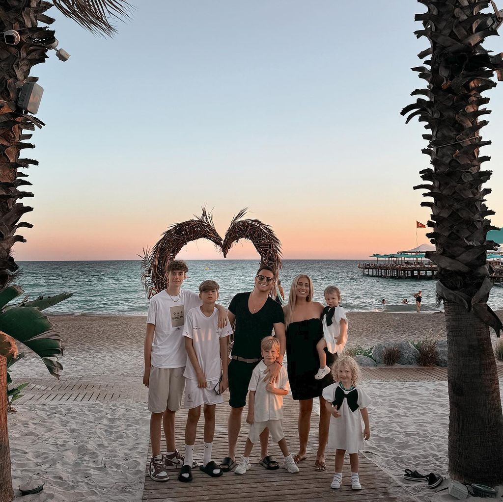 joe swash and stacey solomon and five kids on beach