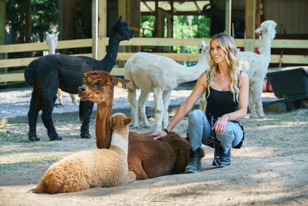 Christina Haack sits with her alpacas in a farm