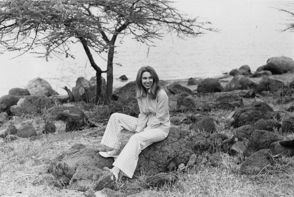 Princess Anne sitting on a rocky beach by a lake while in Ethiopis Anne Elizabeth Alice Louise sitting on a rocky beach by a lake while in Ethiopia