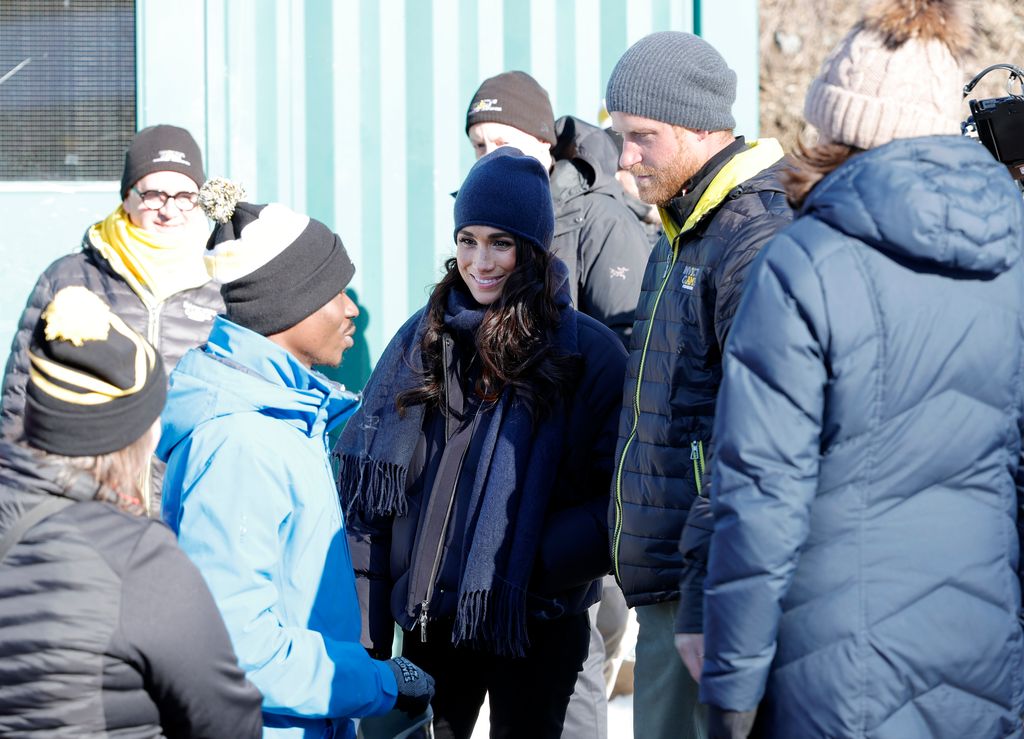 Meghan, Duchess of Sussex and Prince Harry, Duke of Sussex speak to Peacemaker after his run