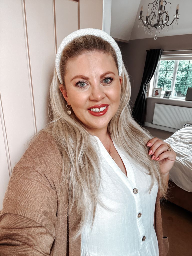 Selfie of a woman wearing a white headband and white top