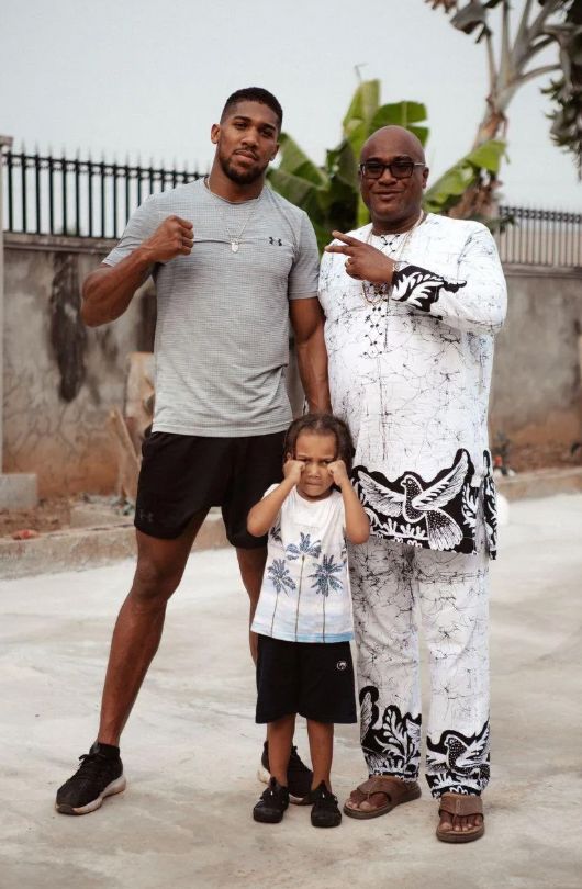 Anthony Joshau with a grown man and his own son