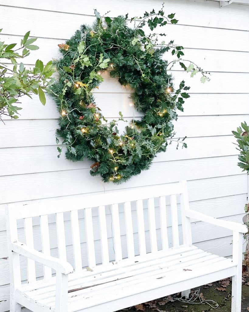 White bench with green wreath on top