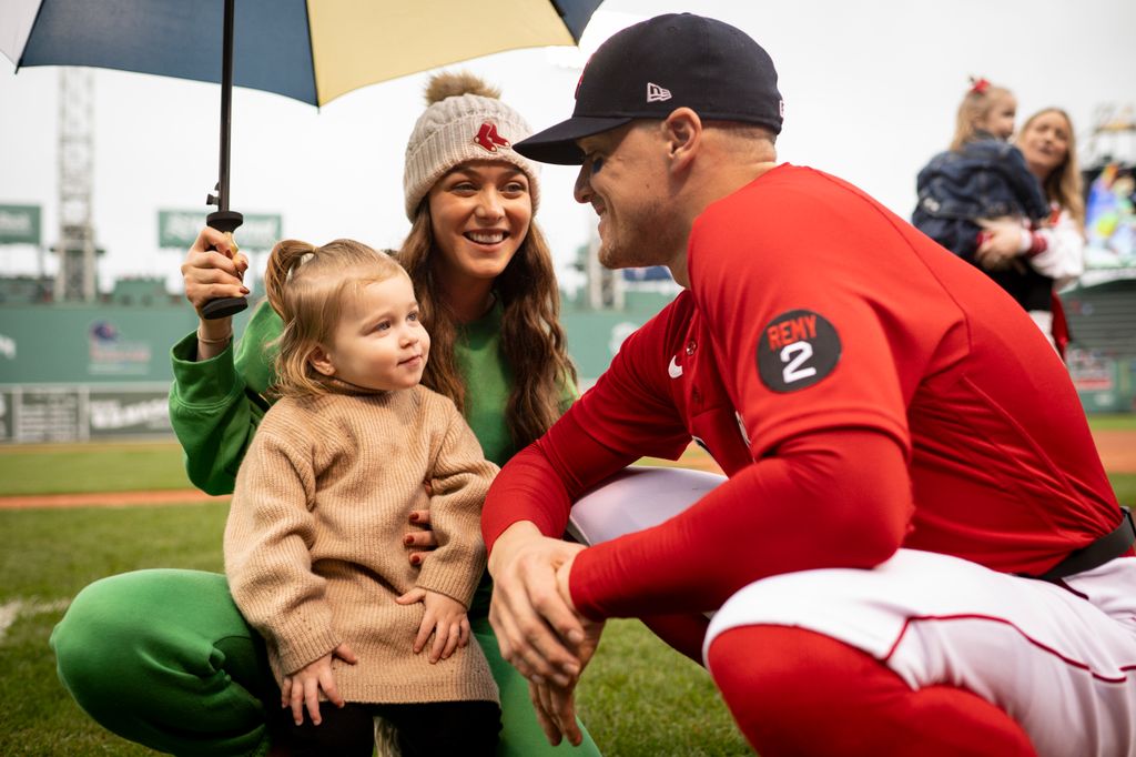 Enrique Hernandez of the Boston Red Sox  reacts with his daughter Penelope and wife Mariana Vicente before a game against the Tampa Bays Rays on October 5, 2022 at Fenway Park in Boston, Massachusetts