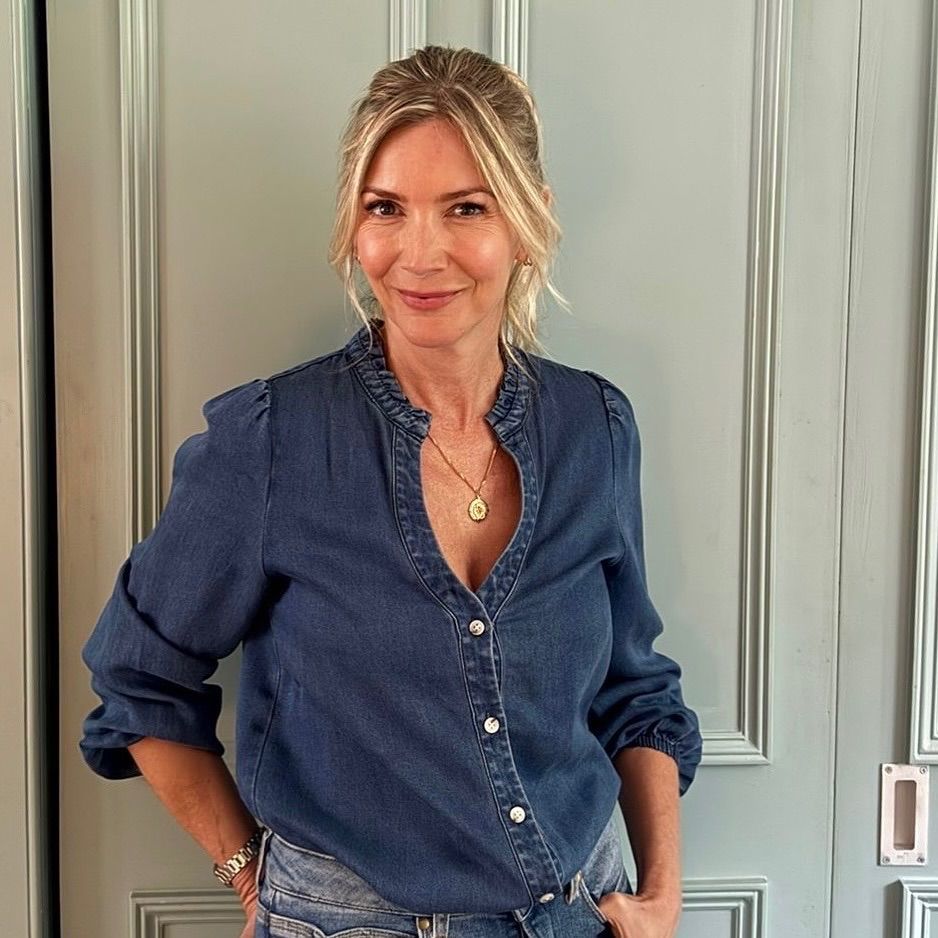 Lisa Faulkner posing in a denim shirt at home