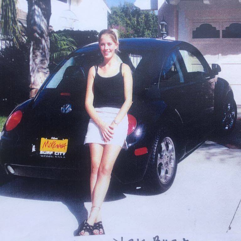 Christina Hall leans on her VW Beetle as a teenager