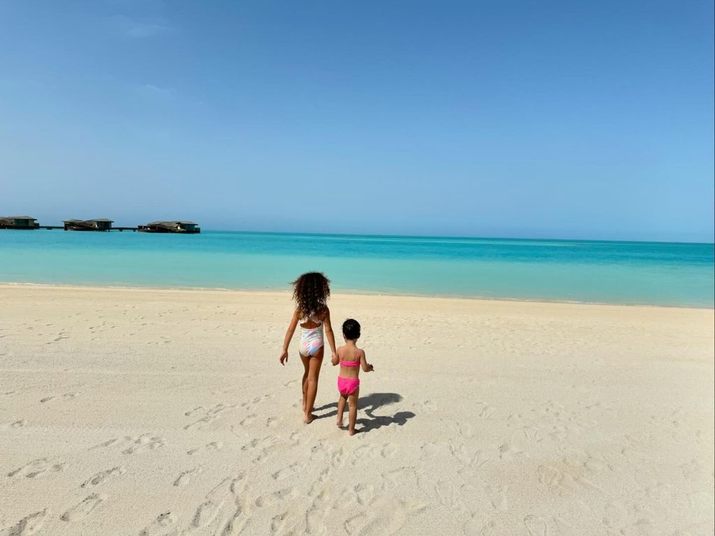 two children walking on the beach