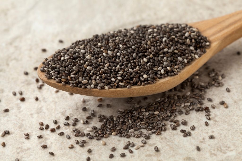 Wooden spoon with raw chia seeds