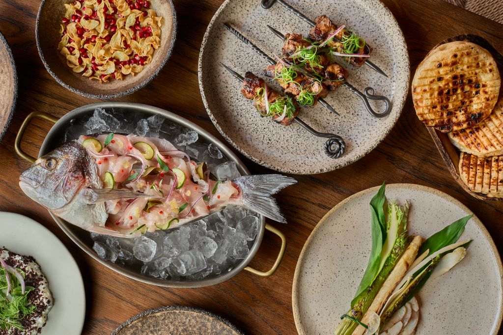 Photo taken from above of several plates of food on a table 