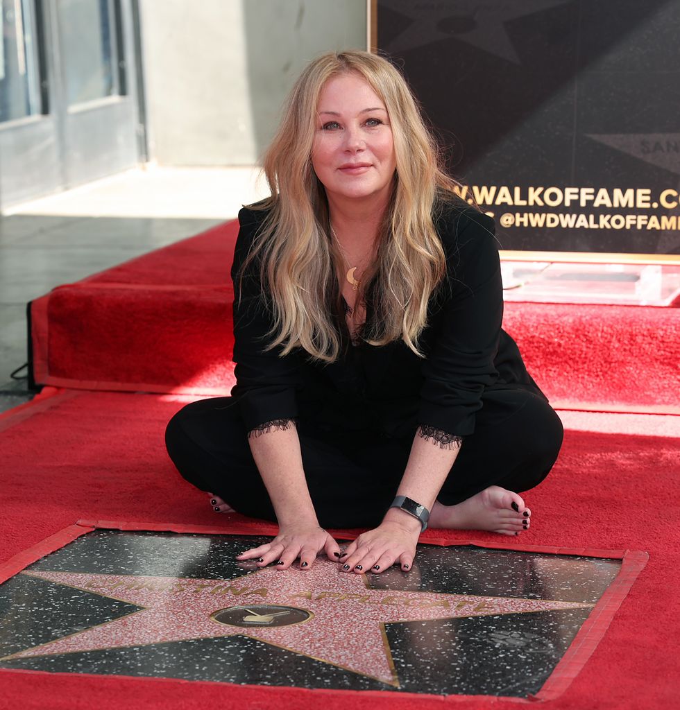 Christina Applegate poses with her star during her Hollywood Walk of Fame Ceremony at Hollywood Walk Of Fame on November 14, 2022 in Los Angeles, California