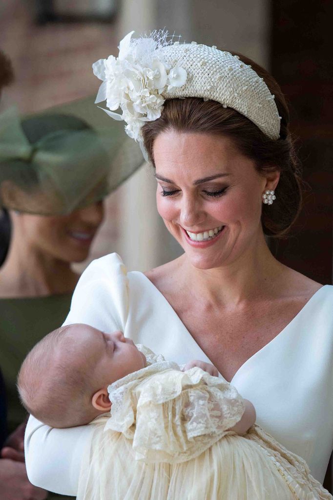 Princess Kate in a headband holding baby prince louis