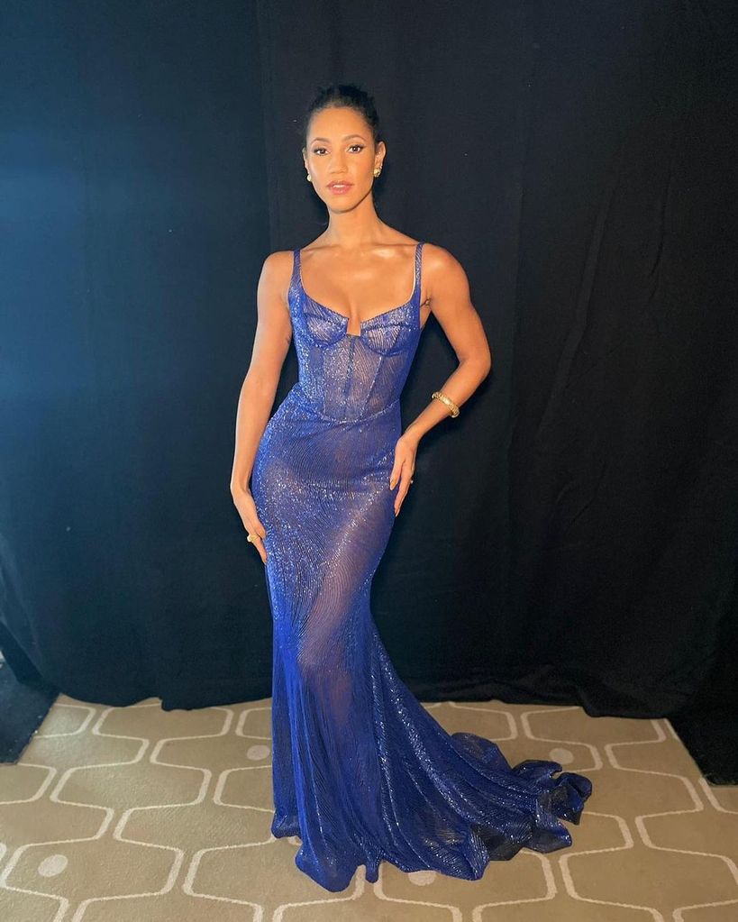 Vick Hope wearing sheer blue dress with low cut neckline
