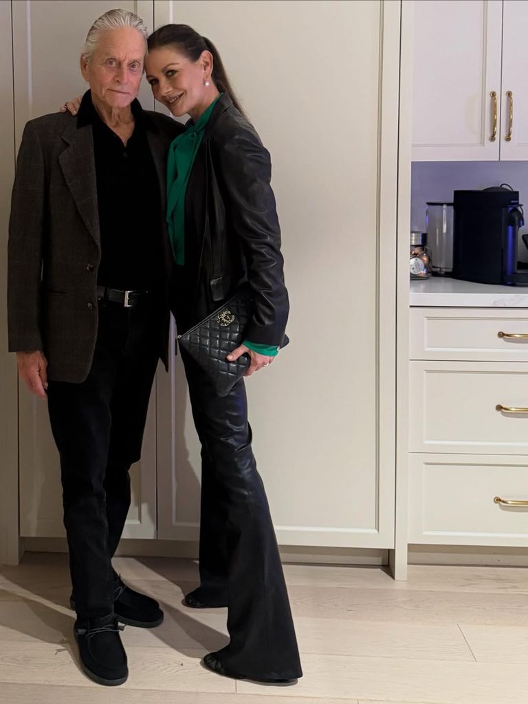  Catherine Zeta Jones in leather outfit posing in kitchen with Michael Douglas