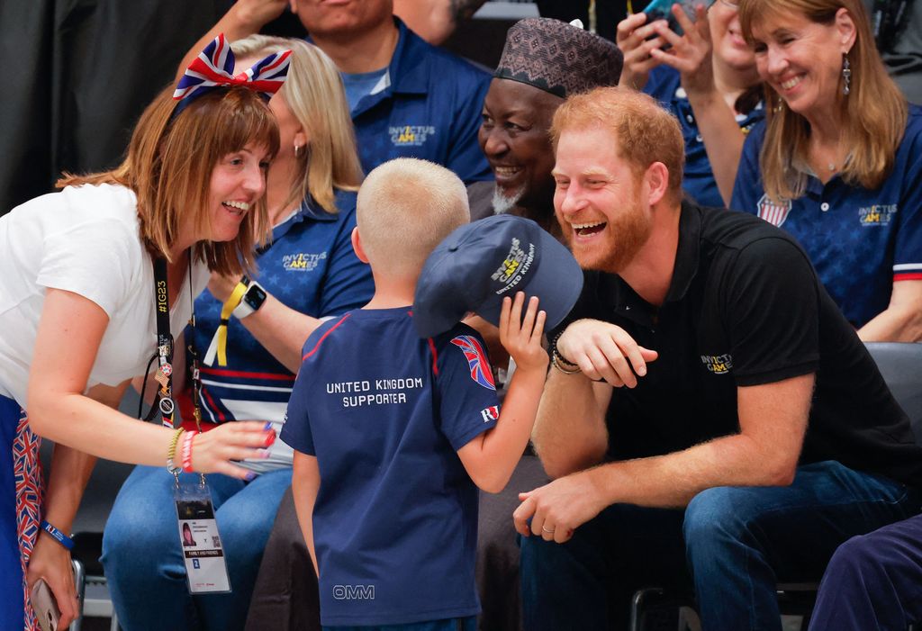Prince Harry talks to young spectator